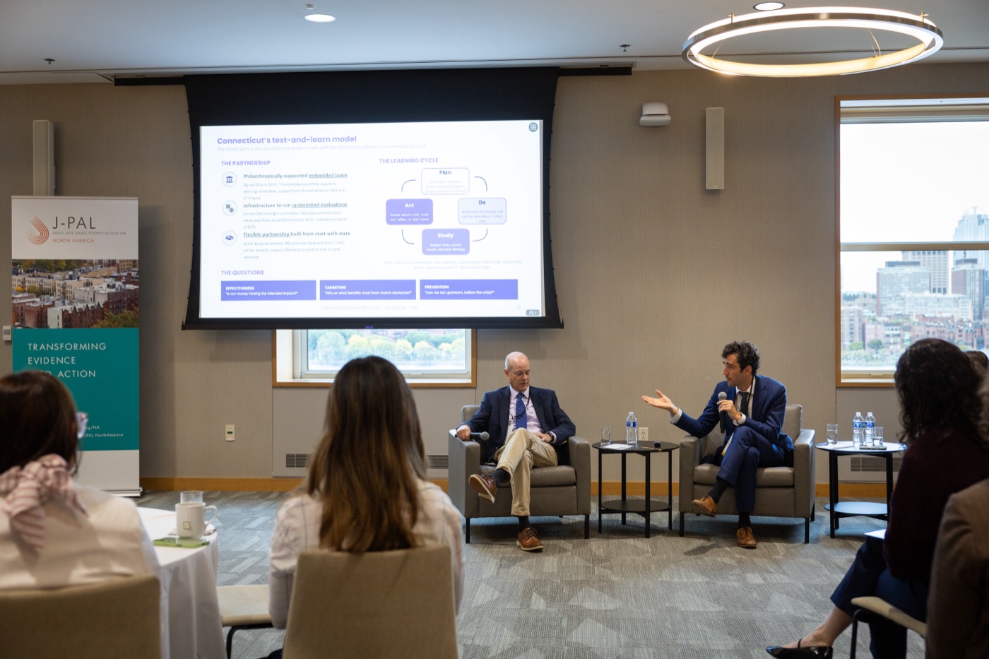 Jacob Wallace on a panel at the Medicaid Learning Lab launch, with Connecticut's test-and-learn model on screen